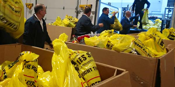 Les Schwab employees transferring collected food to a vehicle for delivery.