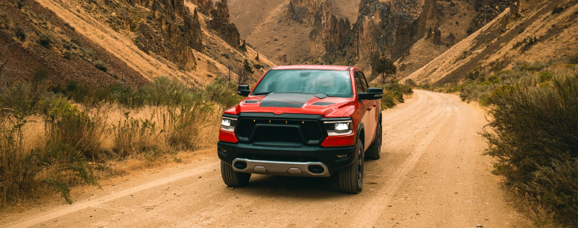 Red pickup on a rural dirt road